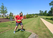 Thumbnail 15 of 18 - a man holding a frisbee on a grass field