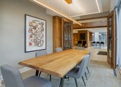 Thumbnail 20 of 40 - a dining room with a wooden table and chairs