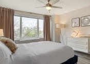 Thumbnail 12 of 40 - a bedroom with a bed and a ceiling fan