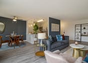 Thumbnail 8 of 40 - a living room and dining room with a couch and a table