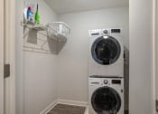 Thumbnail 14 of 40 - a washer and dryer in a small laundry room