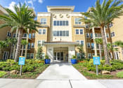 Thumbnail 34 of 34 - Exterior of clubhouse showing the entry and palm trees