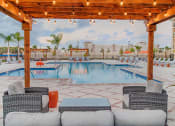 Thumbnail 27 of 34 - Photo of outdoor patio and pool with chairs