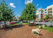 Thumbnail 22 of 33 - A playground with a slide and a horse-shaped swing set.