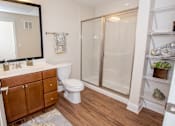 Thumbnail 7 of 33 - A bathroom with a toilet, sink, and shower.