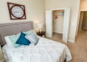 Thumbnail 26 of 33 - A bedroom with a large bed and a clock on the wall.