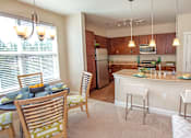 Thumbnail 3 of 33 - A kitchen with a table and chairs.