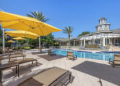 Thumbnail 14 of 26 - exterior swimming pool with yellow umbrellas and a white building in the background