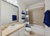 Thumbnail 26 of 26 - a bathroom with a sink and a toilet and a bath tub
