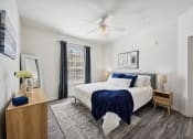 Thumbnail 5 of 26 - a bedroom with a large bed and a ceiling fan