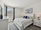 Thumbnail 8 of 26 - a white bedroom with a bed and a window