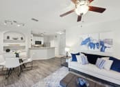 Thumbnail 3 of 26 - a living room with a couch and a ceiling fan