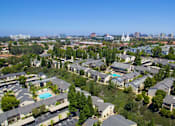 Thumbnail 1 of 27 - A bird's eye view of a residential area with houses and a pool.