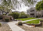 Thumbnail 15 of 39 - A garden with a water feature and a pathway.at Vintage at Scottsdale, SCOTTSDALE, AZ 85260
