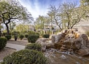 Thumbnail 23 of 39 - A small waterfall in a garden with rocks and shrubs.at Vintage at Scottsdale, Arizona