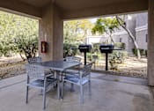 Thumbnail 26 of 39 - A patio with a table and chairs and a mailbox.at Vintage at Scottsdale, SCOTTSDALE, AZ 85260