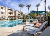 Thumbnail 8 of 39 - A pool surrounded by sun loungers and palm trees.at Vintage at Scottsdale, SCOTTSDALE, 85260