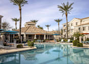 Thumbnail 10 of 39 - A large swimming pool surrounded by palm trees and lounge chairs.at Vintage at Scottsdale, SCOTTSDALE Arizona