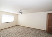 Thumbnail 14 of 22 - A room with a ceiling fan and a window.