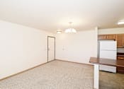 Thumbnail 11 of 22 - A white framed door is in a white room with a brown table and a white framed window.