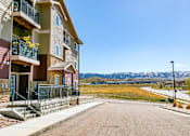 Thumbnail 4 of 22 - Apartment building with a balcony and a view of the mountains.