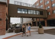 Thumbnail 1 of 26 - two women walking in front of the echo street building