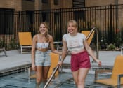 Thumbnail 23 of 26 - two women walking into a swimming pool         in