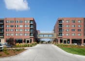 Thumbnail 25 of 26 - a large brick building with a road in front of it