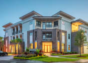 Thumbnail 1 of 26 - Centre Pointe Apartments entrance with landscaping and apartment balconies