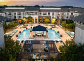 Thumbnail 1 of 19 - The Juncture Apartments aerial view of one resort-style pool and surrounding sundeck