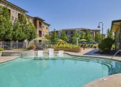 Thumbnail 2 of 22 - Acadia at Cornerstar Apartments - Resort-inspired pool with tanning shelf