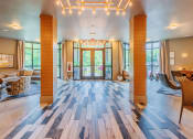 Thumbnail 2 of 26 - Centre Pointe Apartments clubhouse entrance with high ceilings and lounge areas