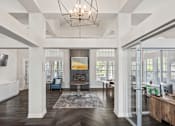 Thumbnail 2 of 22 - A large, open living room with a high ceiling and a chandelier.