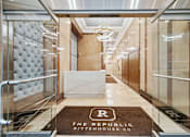 Thumbnail 2 of 24 - A hallway with a brown carpet that says "The Republic Rittenhouse Sq."