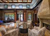 Thumbnail 3 of 24 - Belle Harbour Apartments clubhouse interior with fireplace