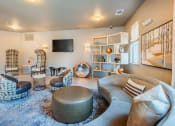 Thumbnail 3 of 26 - Centre Pointe Apartments clubhouse lounge area with several seating areas and a television