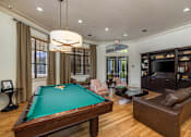 Thumbnail 3 of 22 - A room with a pool table and a couch.