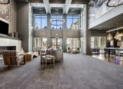 Thumbnail 4 of 30 - a large living room with a fireplace and large windows
