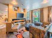 Thumbnail 5 of 26 - Centre Pointe Apartments clubhouse with television and conversation area