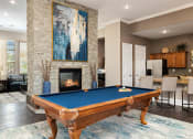 Thumbnail 5 of 22 - Cordillera Ranch Apartments billiards table and indoor fireplace