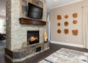 Thumbnail 6 of 22 - Cordillera Ranch Apartments indoor fireplace and TV