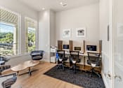 Thumbnail 7 of 32 - A room with a desk and chairs.