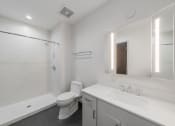 Thumbnail 10 of 36 - a bathroom with a sink toilet and a shower