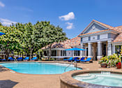 Thumbnail 9 of 22 - A pool with a hot tub in front of a house.