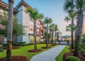 Thumbnail 10 of 26 - Centre Pointe Apartments landscaped walkway to pool area