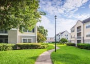 Thumbnail 10 of 23 - The Colony at Deerwood Apartments - Manicured landscapes with walkways