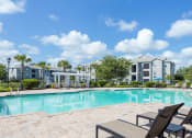 Thumbnail 9 of 24 - Courtney Station Apartments - Resort-style pool with pergola and seating area