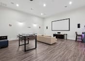 Thumbnail 10 of 29 - Game room with foosball and arcade games - First and Main Apartments