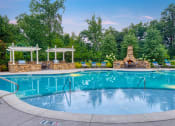 Thumbnail 10 of 19 - The Oaks at Johns Creek - Saltwater swimming pool with BBQ grills and fireplace social area