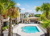 Thumbnail 11 of 26 - Centre Pointe Apartments resort-style pool area with surrounding sundeck